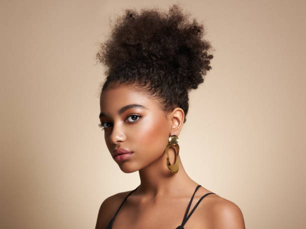Edlizer Beauty campaign portrait — luminous complexion with sculptural gold earrings